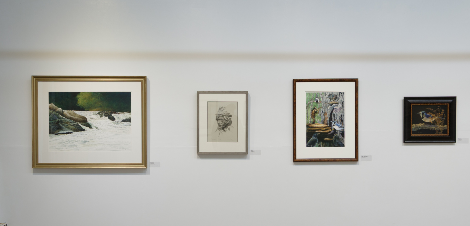 L to R: Leonard Paul, North River (2025), watercolour on paper; Elder (n.d.), lithograph on paper; Magic Flute (2022), watercolour on paper; Blue Jay (2020), oil on paper. Image courtesy of NSCAD Treaty Space Gallery. Photo: Jair Armstrong.